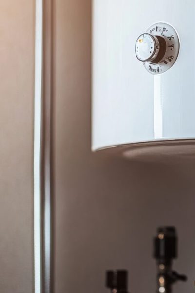 Technician repairs a water heater at home.